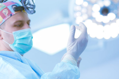 Man surgeon at work in operating room