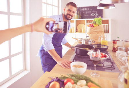 Portrait of handsome man filming cooking show or blogの写真素材