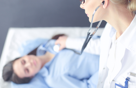 Doctor and patient discussing something while sitting at the table . Medicine and health care conceptの写真素材
