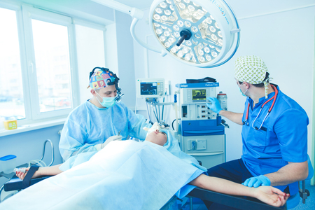 Man surgeon at work in operating roomの写真素材