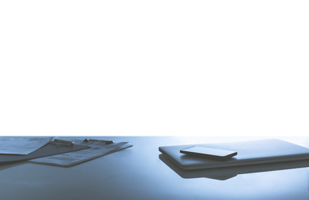 Office desk table with notebook,keyboard,smart phone and pen Top view on white backgroundの写真素材