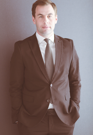 Portrait of a confident mature businessman standing outside.の写真素材