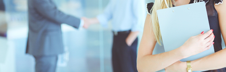 Portrait of young businesswoman in office with colleagues in the background .の写真素材