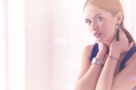 Young woman sitting on a chair isolated over white backgroundの写真素材