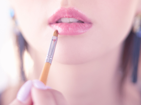 Beautiful girl with cosmetic powder brush for make up. Makeup. Make-up applying for perfect skinの写真素材