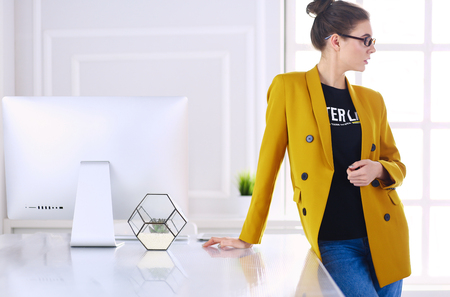 Portrait of a beautiful business woman standing near her workplaceの写真素材