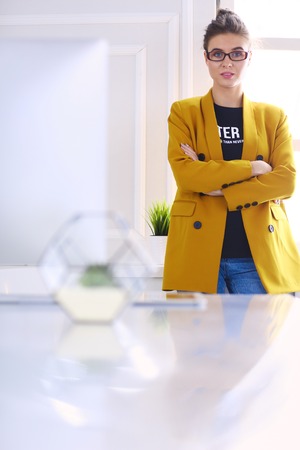 Portrait of a beautiful business woman standing near her workplaceの写真素材