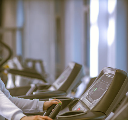 Beautiful girl at the gym exercising on trainers. Beautiful girl