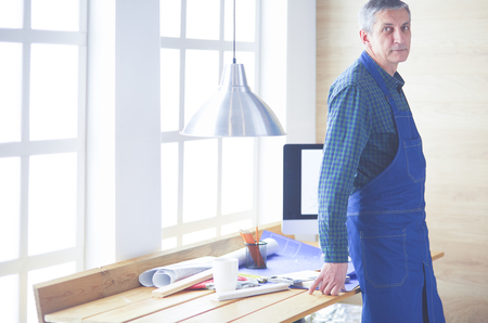 Architect working on drawing table in officeの写真素材