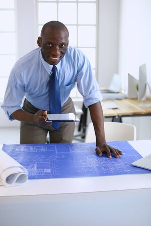 Portrait of an handsome black businessman standing in officeの写真素材
