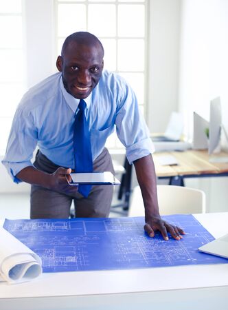 Portrait of an handsome black businessman standing in officeの写真素材