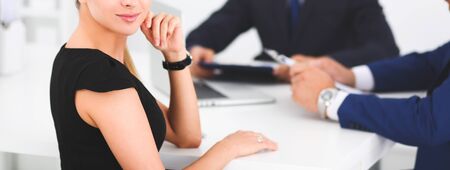 Business people sitting and discussing at meeting, in officeの写真素材