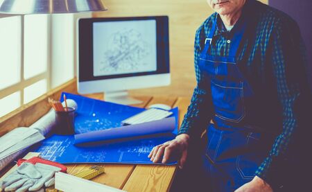 Architect working on drawing table in officeの写真素材
