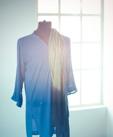 Mannequin with blue cloth in room, on grey backgroundの写真素材