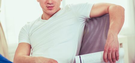 Young man resting in armchair. Joy of lifeの写真素材