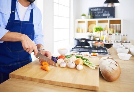 Man preparing delicious and healthy food in the home kitchenの写真素材