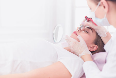 A young girl having red lips permanent makeup, micropigmentation