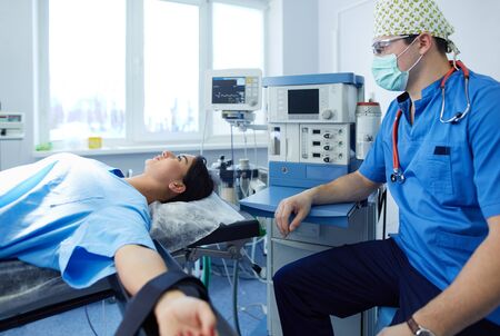 Male surgeon on background in operation roomの写真素材