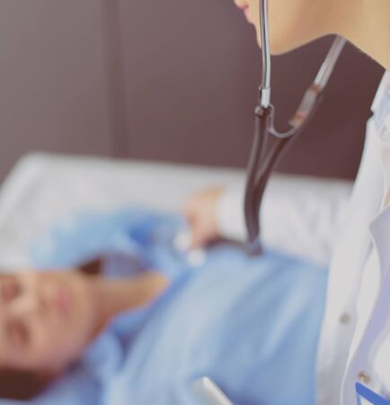 Doctor and patient discussing something while sitting at the table . Medicine and health care conceptの写真素材