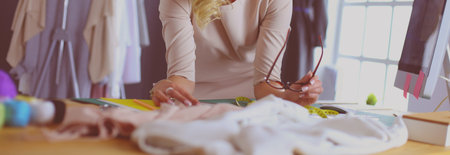 Fashion designer woman working on her designs in the studio.