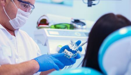 Dentist and his assistant carrying out a thorough examination.の写真素材