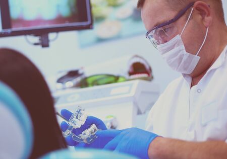 Beautiful senior woman at dentist having dental treatment at dentist's office.の写真素材