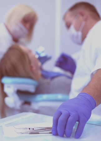 Dentist and his assistant carrying out a thorough examination.の写真素材