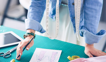 Fashion designer woman working on her designs in the studio