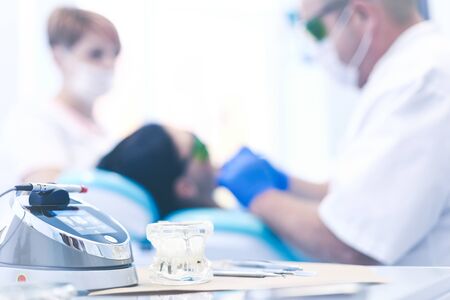 Beautiful senior woman at dentist having dental treatment at dentist's office.の写真素材