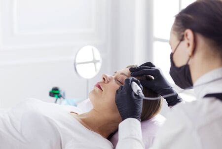 Microblading eyebrows work flow in a beauty salon.の写真素材