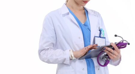 Female doctor using a digital tablet and standing on white background. Woman doctorsの写真素材
