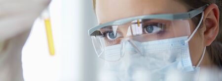 Researcher, doctor, scientist or laboratory assistant working with plastic medical tubes in modern lab or hospitalの写真素材