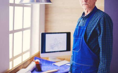 Architect working on drawing table in office.の写真素材