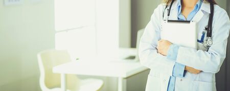 Female doctor using tablet computer in hospital lobby.の写真素材
