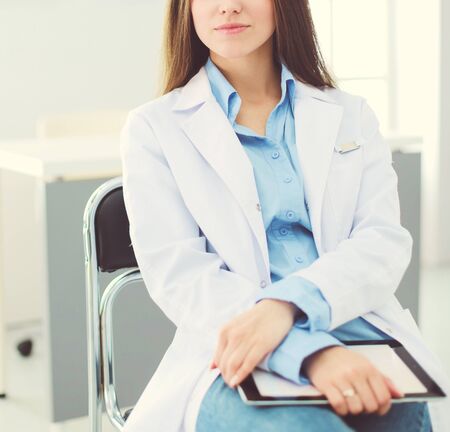 Female doctor using tablet computer in hospital lobbyの写真素材