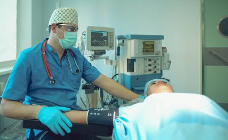 Man surgeon at work in operating room.の写真素材