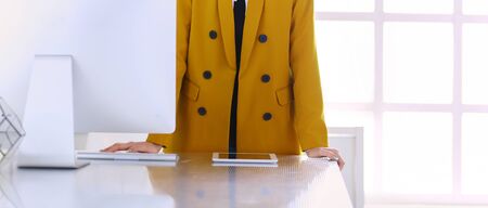 Portrait of a beautiful business woman standing near her workplaceの写真素材