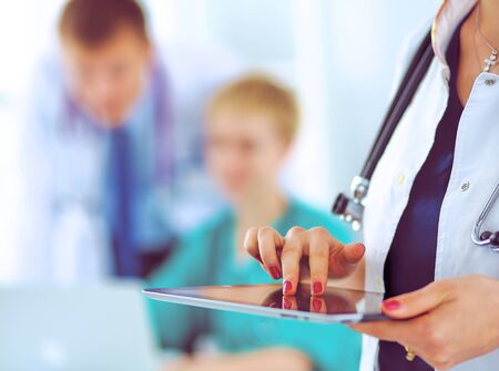 Young woman doctor holding a tablet pc .の写真素材
