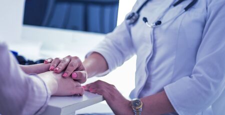 Female doctor giving a consultation to a patient and explaining medical informations and diagnosis.の写真素材