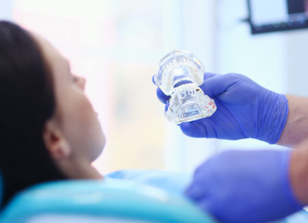 Portrait of a dentist who treats teeth of young woman patient