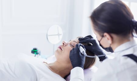 Microblading eyebrows work flow in a beauty salon.の写真素材
