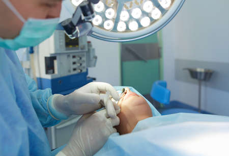 Man surgeon at work in operating room.の写真素材