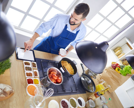Man preparing delicious and healthy food in the home kitchen