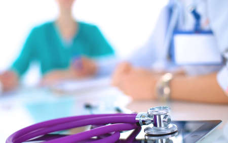 Young female doctor sitting at the deskの写真素材