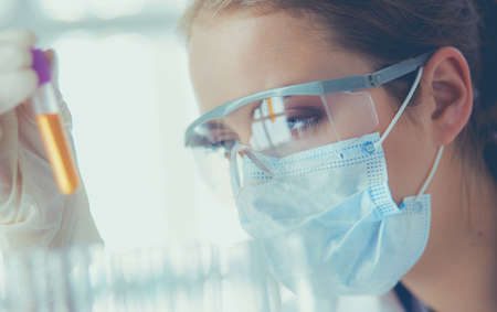 Researcher, doctor, scientist or laboratory assistant working with plastic medical tubes in modern lab or hospitalの写真素材