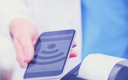 Doctor is holding payment terminal in hands. Paying for health care. Doctor