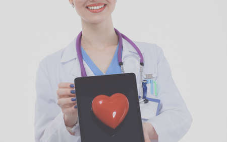 Young woman doctor holding a red heart, isolated on white background. Woman doctorの写真素材