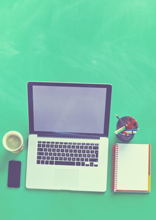 Office desk table with laptop, smart phone, photocameraの写真素材