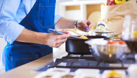 Man preparing delicious and healthy food in the home kitchen