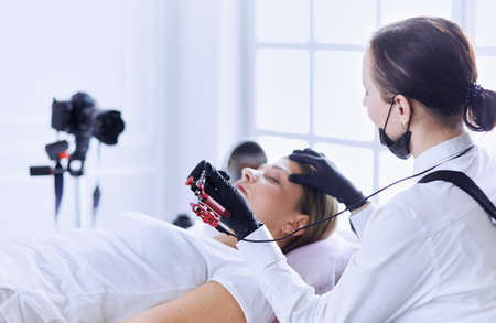 Microblading eyebrows work flow in a beauty salon.の写真素材